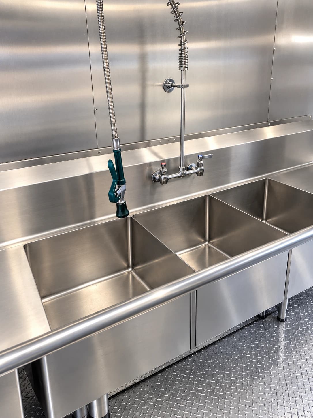 26 ft baby bulk kitchen three-compartment sink with pre-rinse faucet.