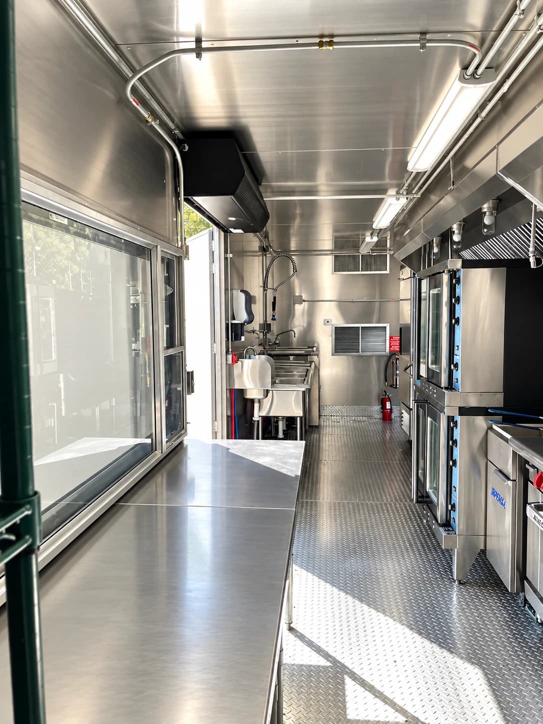 Mobile kitchen trailer stainless steel prep area.